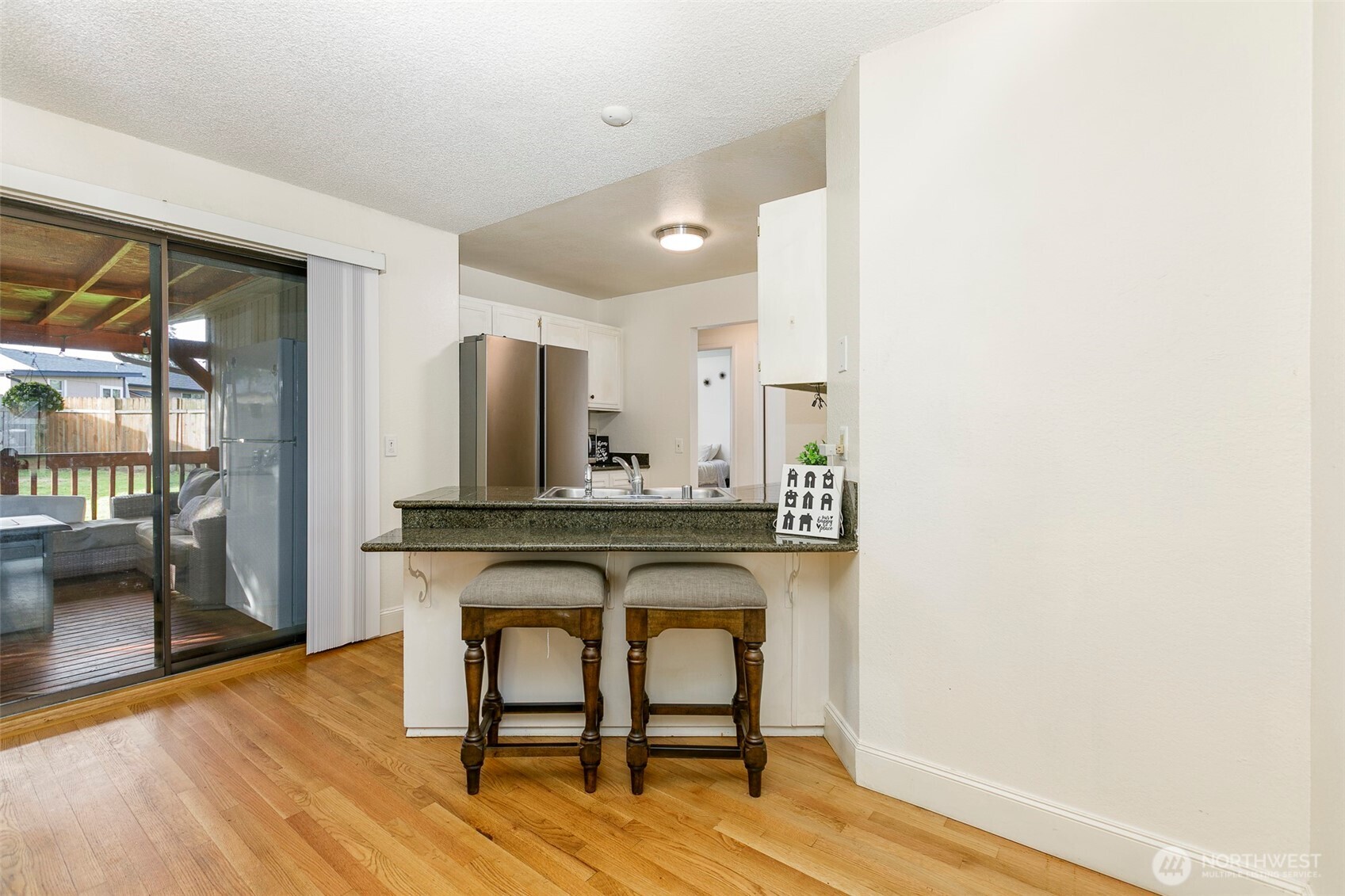 4003 Northeast 6th Court Renton, WA 98056 - Photo 7 of 20 a view of a hallway with wooden floor and a bathroom