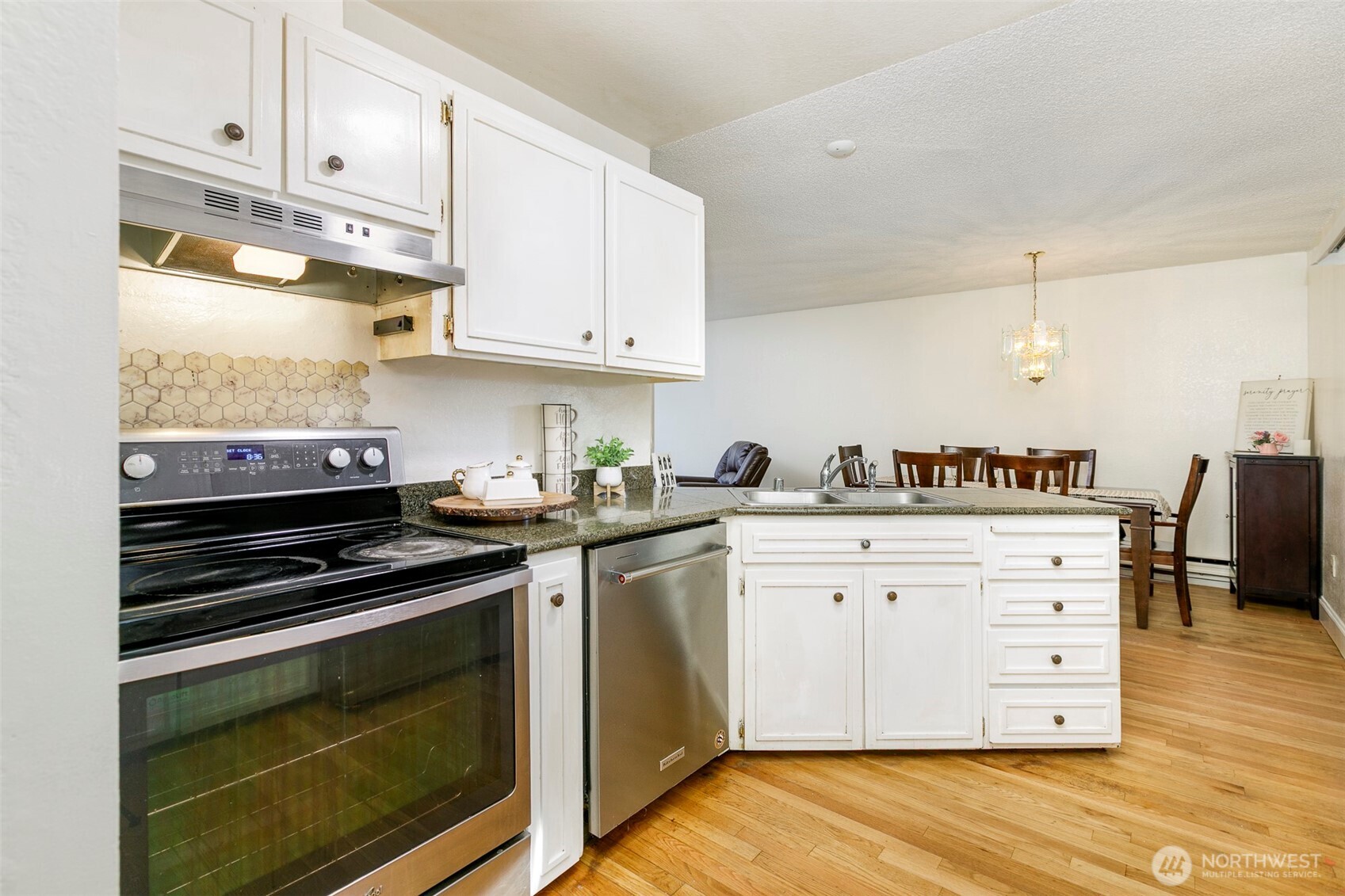 4003 Northeast 6th Court Renton, WA 98056 - Photo 8 of 20 a kitchen with granite countertop cabinets and appliances