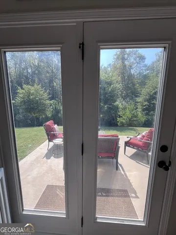 a view of a hallway with wooden floor and cabinet