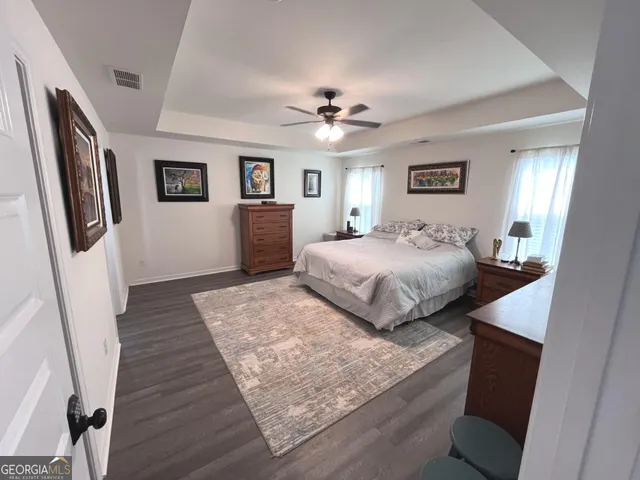 a living room with furniture a window and a flat screen tv