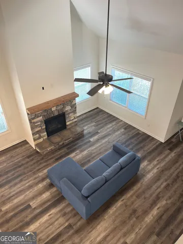 a view of livingroom with furniture wooden floor chandelier
