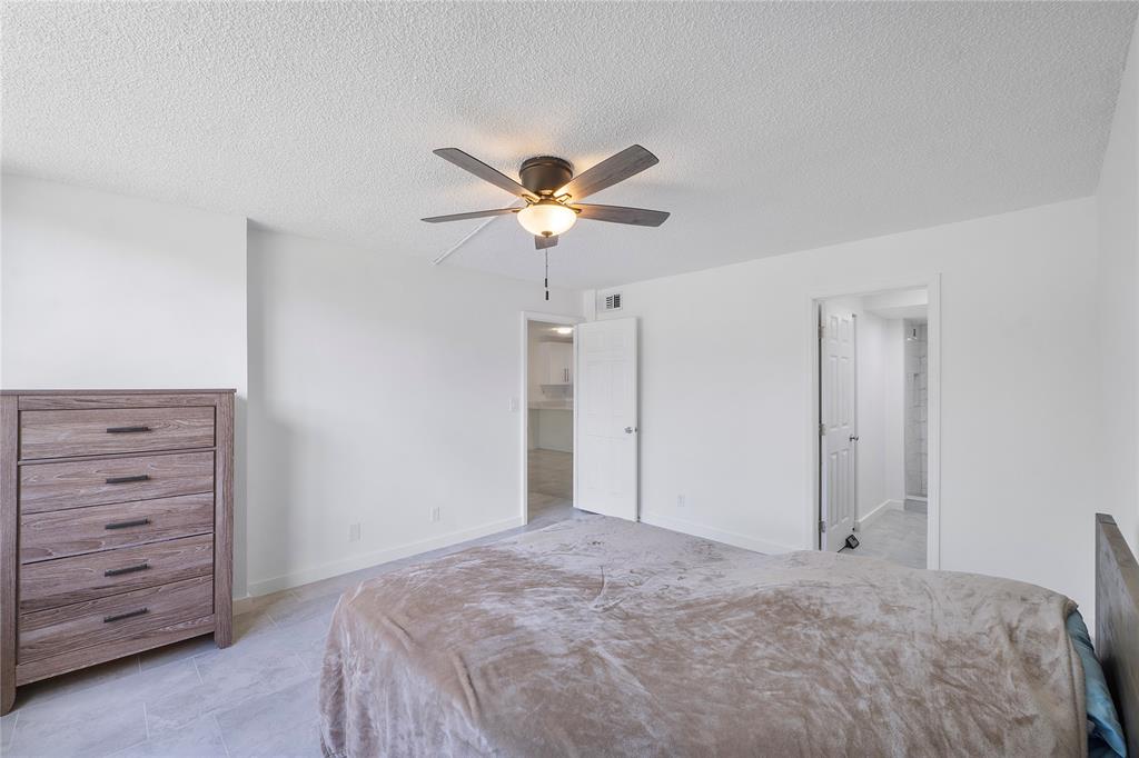 3751 Environ Boulevard, Unit 243 Lauderhill, FL 33319 - Photo 14 of 24 a bedroom with a bed and a ceiling fan
