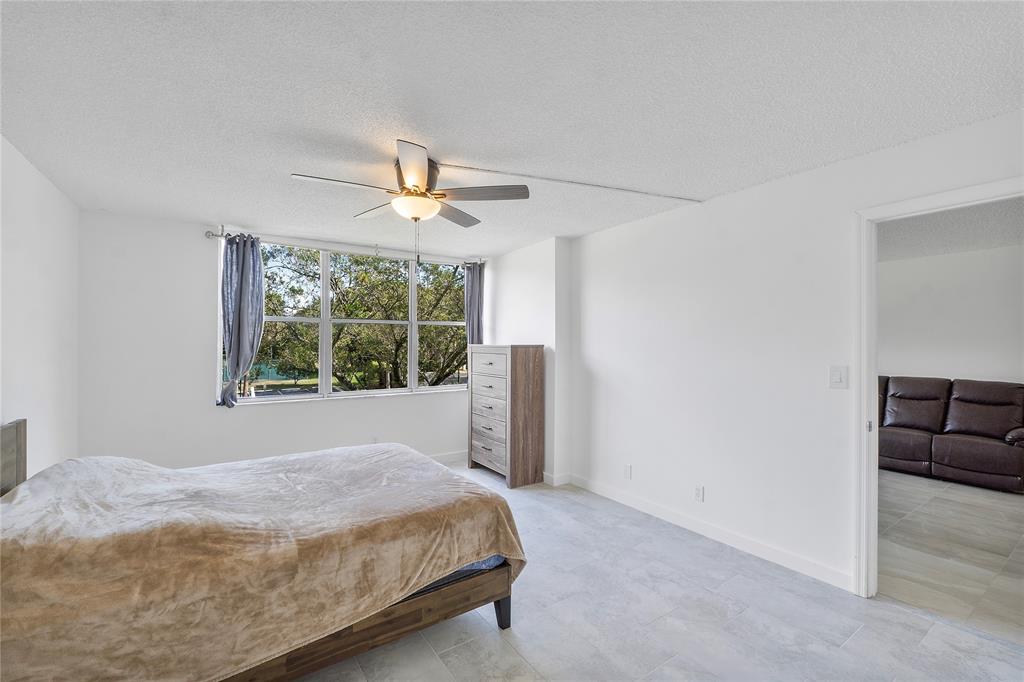 3751 Environ Boulevard, Unit 243 Lauderhill, FL 33319 - Photo 15 of 24 a bedroom with a bed and a window
