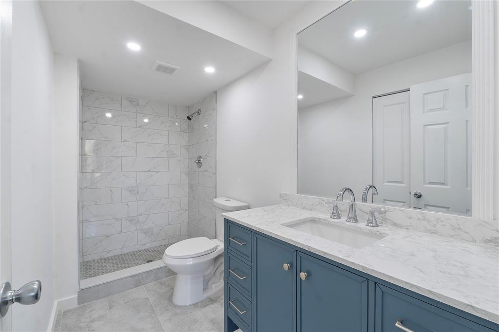 3751 Environ Boulevard, Unit 243 Lauderhill, FL 33319 - Photo 16 of 24 a bathroom with a granite countertop sink a toilet and shower