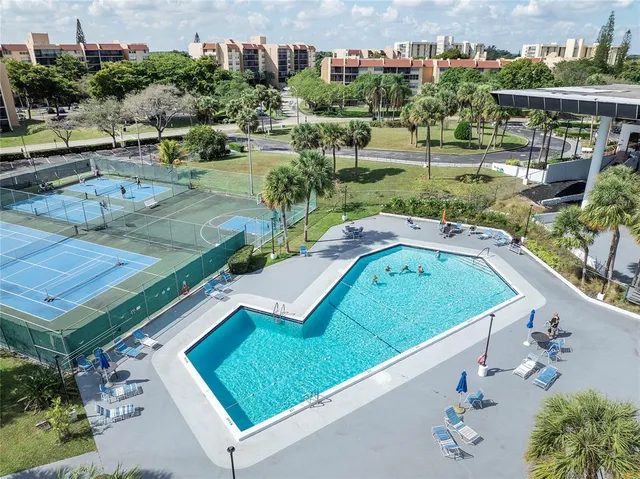 an aerial view of a house with a garden and lake view