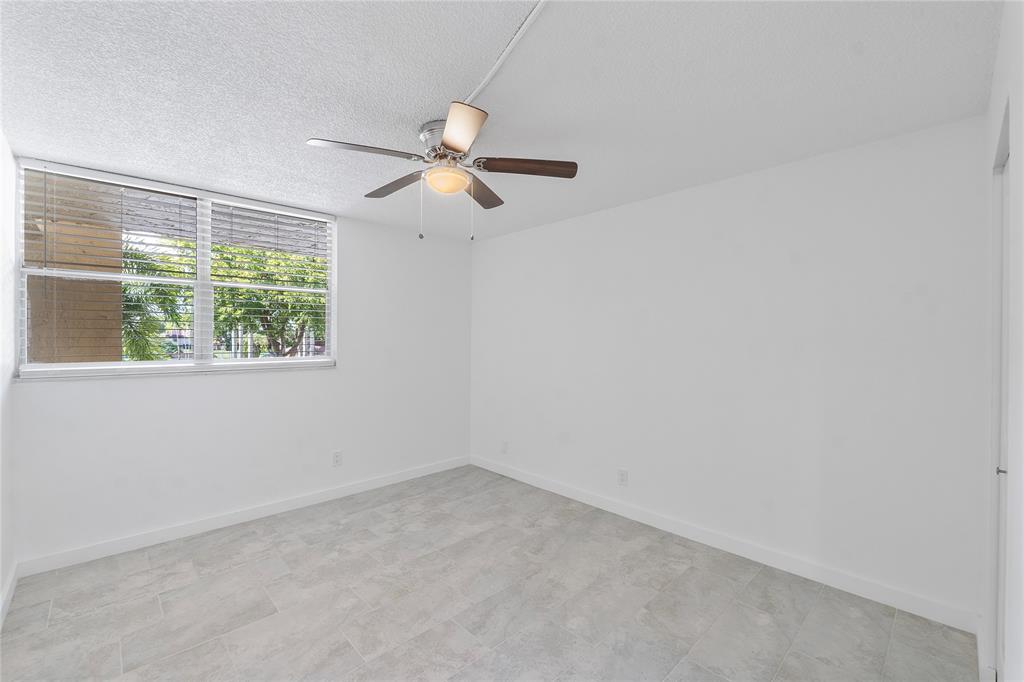 3751 Environ Boulevard, Unit 243 Lauderhill, FL 33319 - Photo 9 of 24 an empty room with a window and a fan