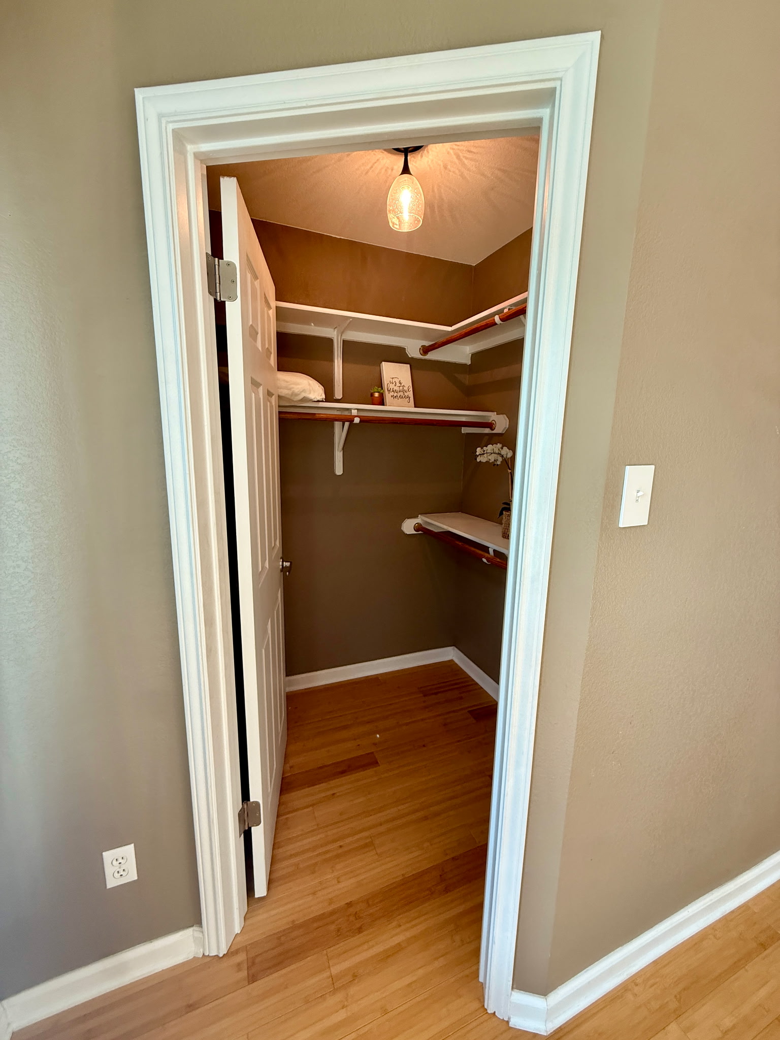 904 Double File Cove Round Rock, TX 78665 - Photo 20 of 25 An organized walk-in closet boasts classic hardwood flooring and plentiful built-in shelving.
