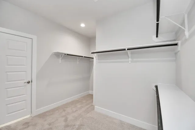 an empty room with closet and ceiling fan