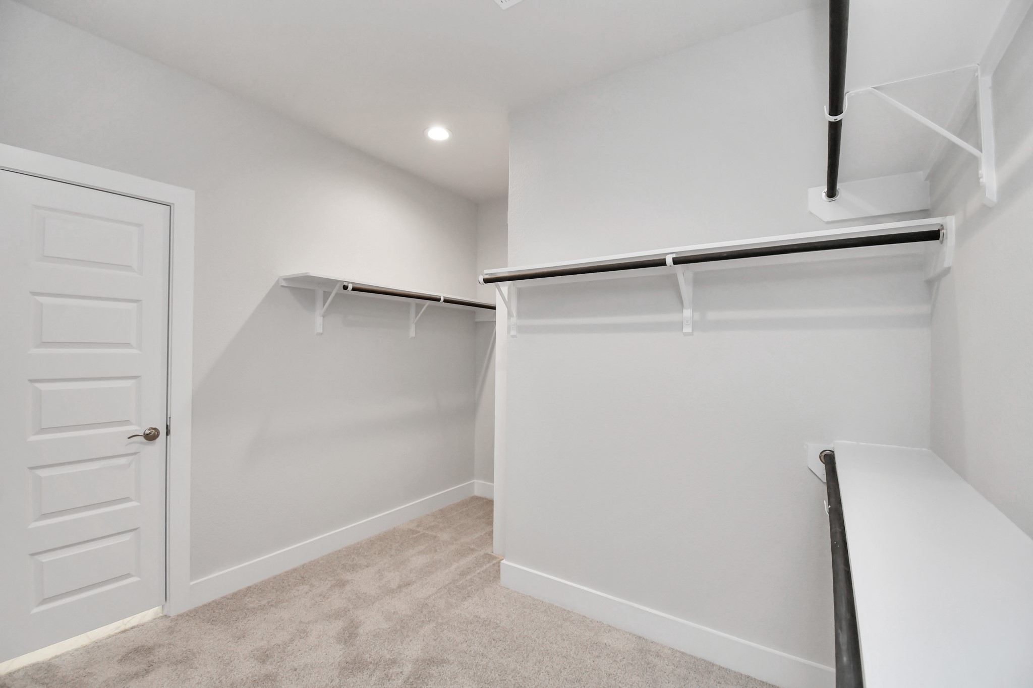24722 Skerne Woods Drive Spring, TX 77373 - Photo 25 of 39 Walk-in closet that epitomizes luxury and practicality. This generously sized space features built-in shelving, offering abundant room for impeccable organization. High ceilings and recessed lighting create a bright and welcoming ambiance. Sample photo of completed home with similar floor plan. Actual colors and selections may vary.