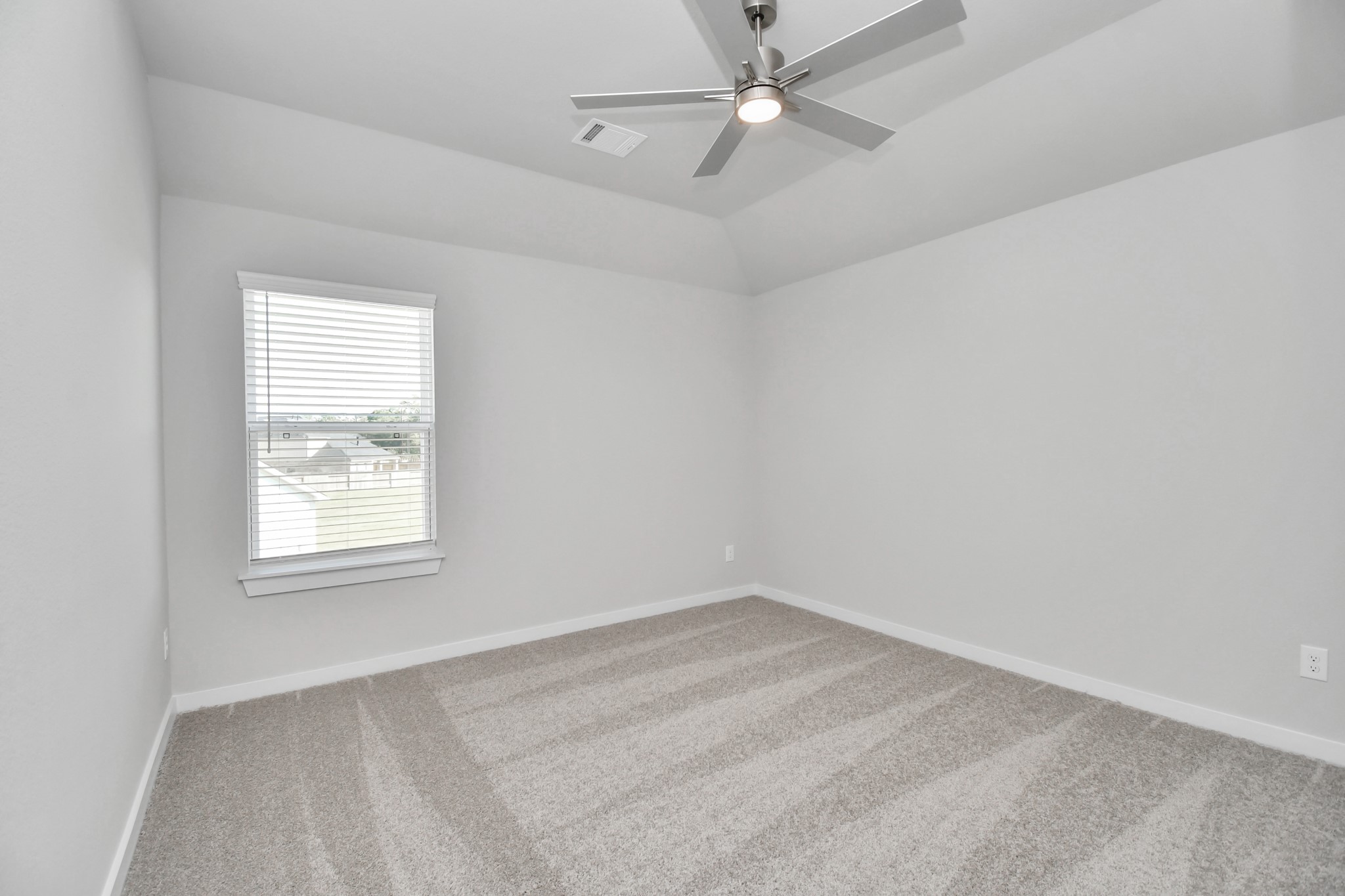 24722 Skerne Woods Drive Spring, TX 77373 - Photo 27 of 39 Secondary bedroom features plush carpeting, large windows that let in plenty of natural light, bright paint, and spacious closets. Sample photo of completed home with similar floor plan. Actual colors and selections may vary.