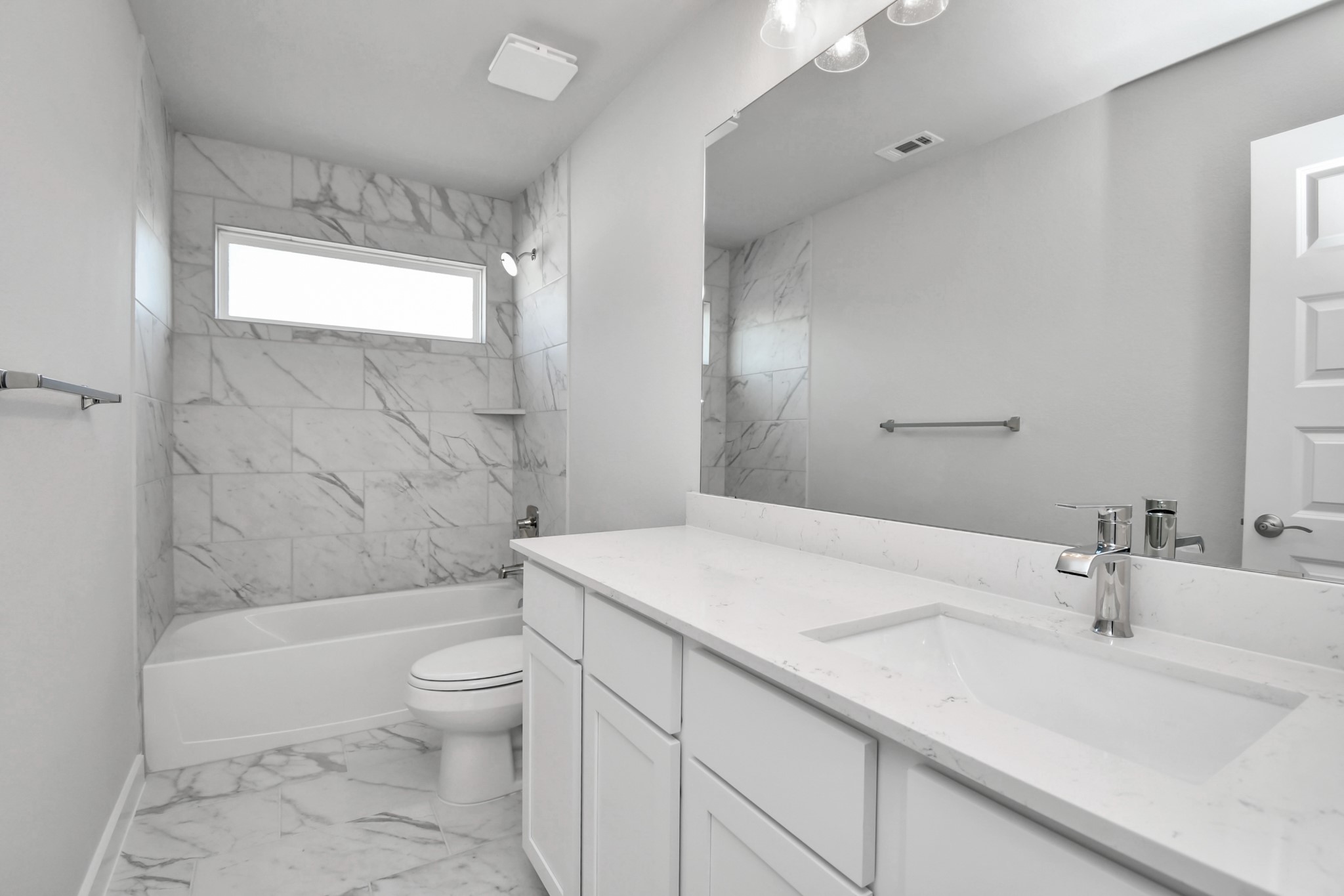 24722 Skerne Woods Drive Spring, TX 77373 - Photo 29 of 39 Secondary bath features tile flooring, bath/shower combo with tile surround, light stained wood cabinets, beautiful light countertop. Sample photo of completed home with similar floor plan. Actual colors and selections may vary.