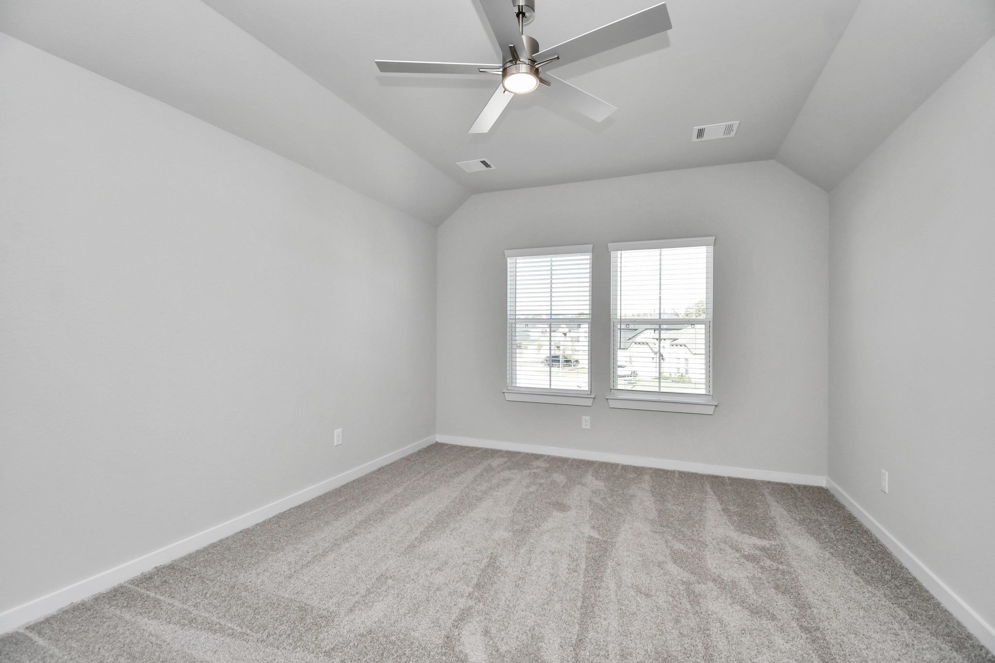 24722 Skerne Woods Drive Spring, TX 77373 - Photo 36 of 39 Secondary bedroom features plush carpeting, large windows that let in plenty of natural light, bright paint, and spacious closets. Sample photo of completed home with similar floor plan. Actual colors and selections may vary.