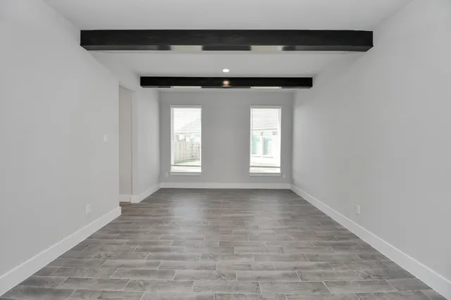 a large kitchen with cabinets wooden floor and stainless steel appliances