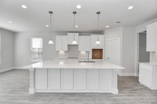 a large white kitchen with a large window