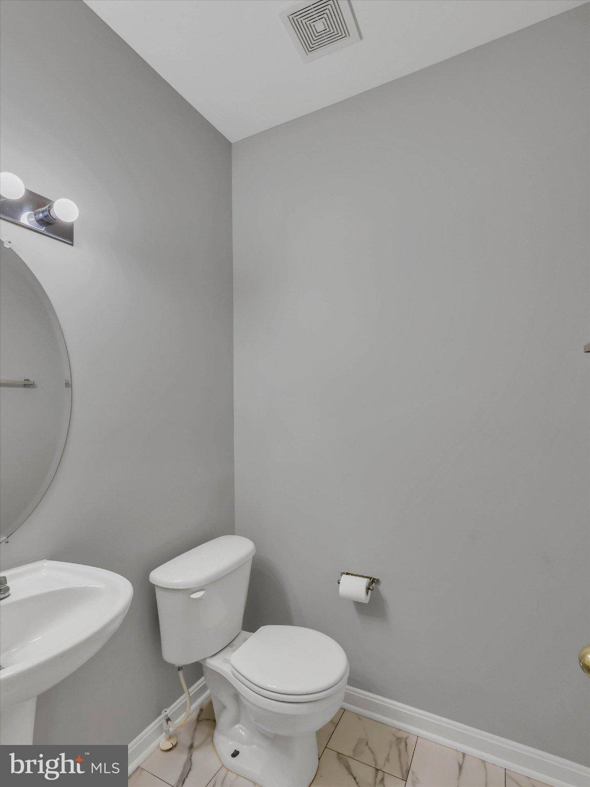 8104 Pepper Ridge Way Gaithersburg, MD 20877 - Photo 21 of 62 Sleek and modern powder room design.
