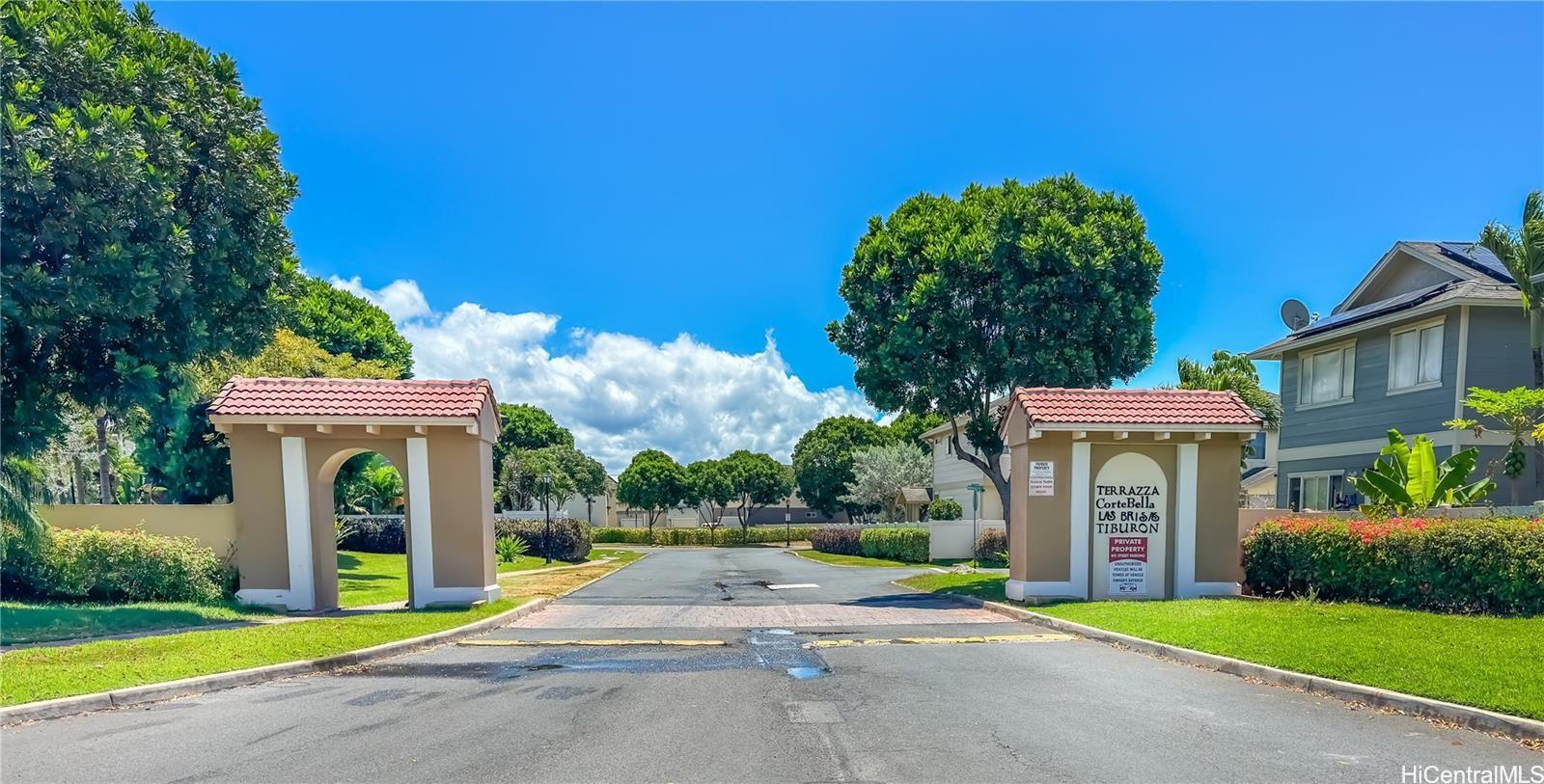 91-241 Makalauna Place, Unit 15 Ewa Beach, HI 96706 - Photo 15 of 15 a view of a brick building with a big yard and large trees