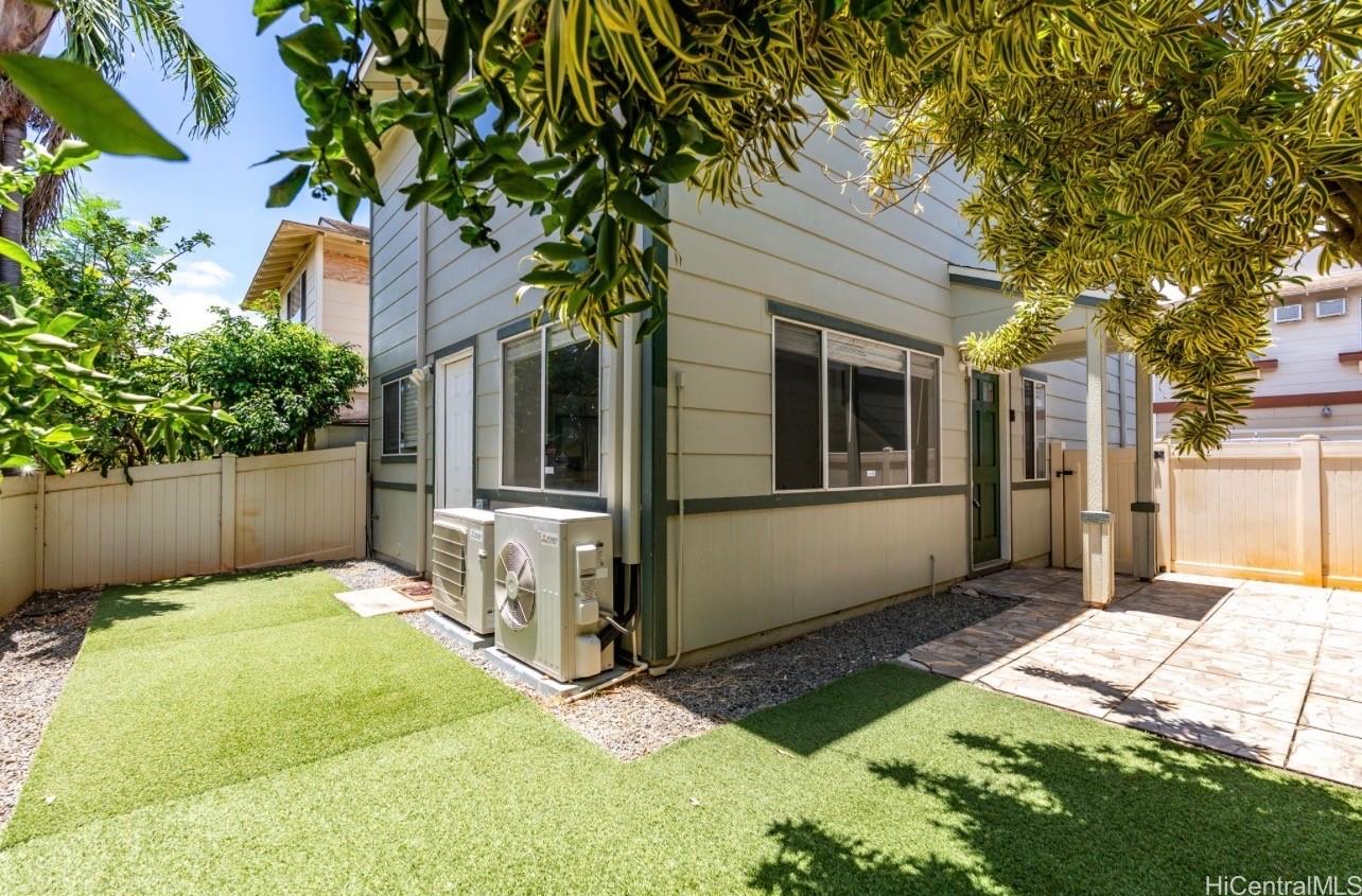 91-241 Makalauna Place, Unit 15 Ewa Beach, HI 96706 - Photo 2 of 15 a front view of a house with a yard
