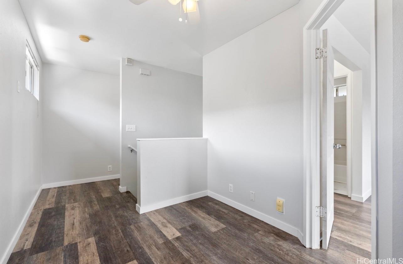 91-241 Makalauna Place, Unit 15 Ewa Beach, HI 96706 - Photo 9 of 15 an empty room with wooden floor and entrance