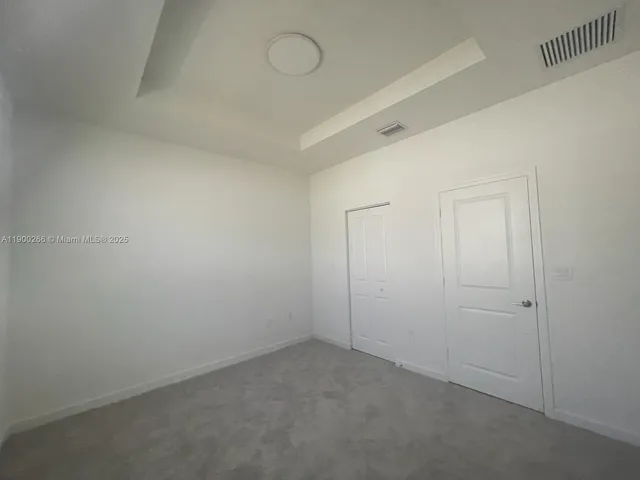 an empty room with a bathroom and a sink