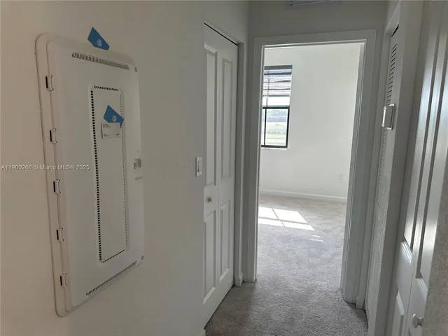 a view of a hallway with washer and dryer
