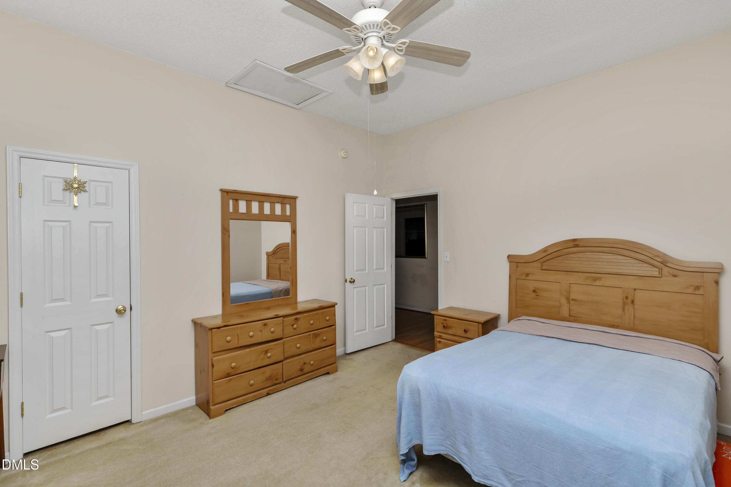 100 East E Street Erwin, NC 28339 - Photo 11 of 27 a bedroom with a bed and a chandelier