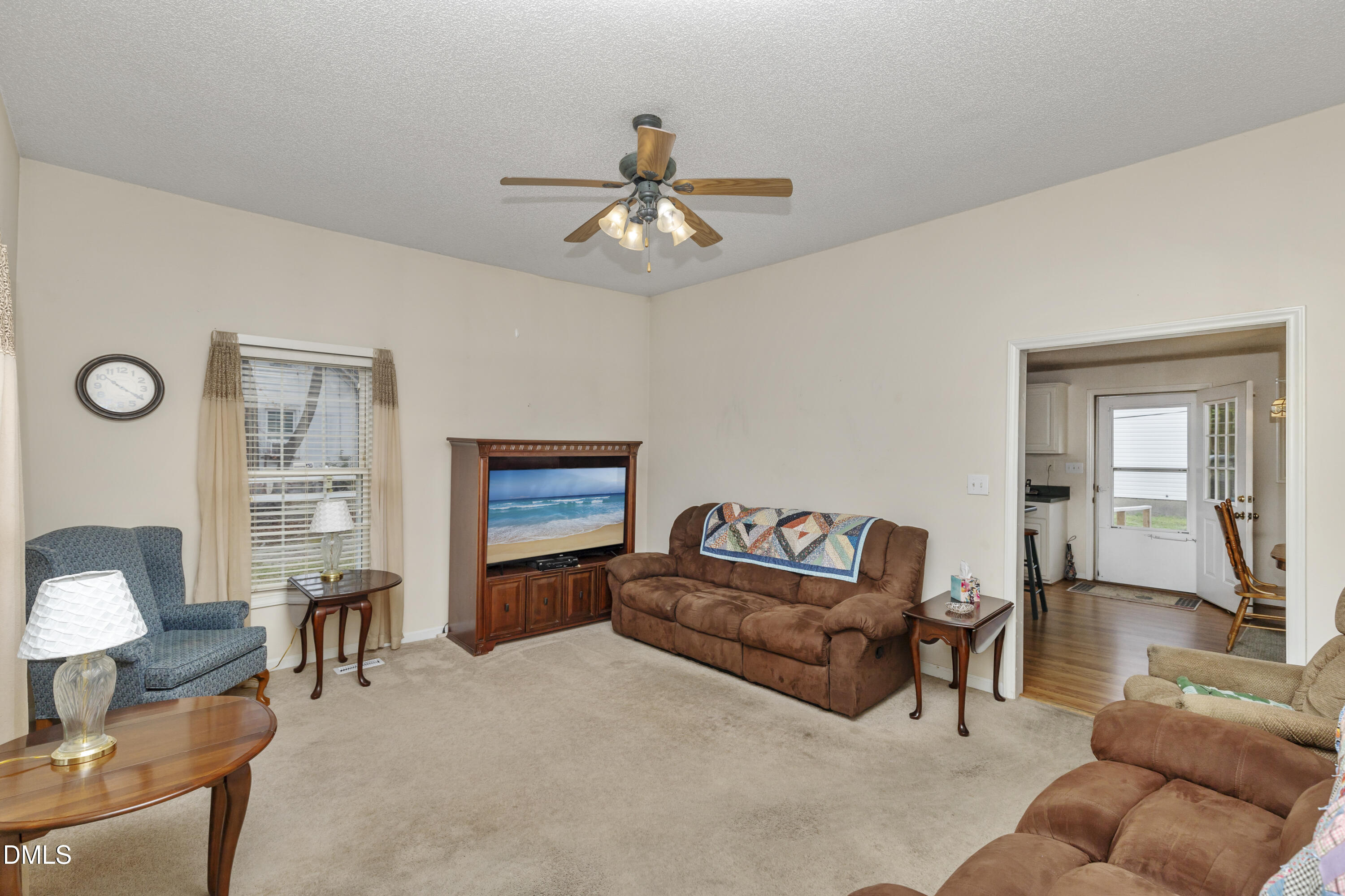 100 East E Street Erwin, NC 28339 - Photo 16 of 27 a living room with furniture a ceiling fan and a window