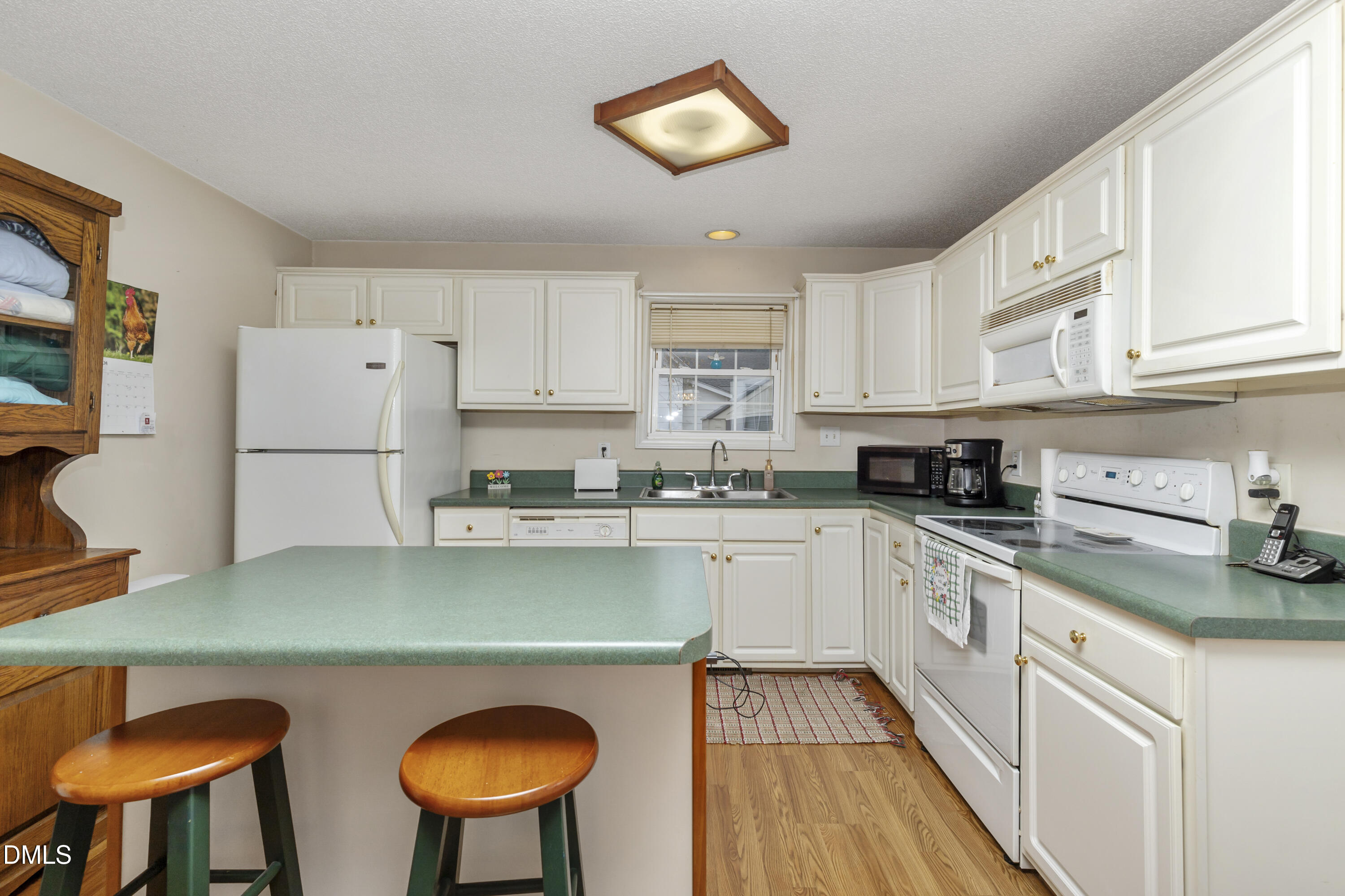 100 East E Street Erwin, NC 28339 - Photo 19 of 27 a kitchen with stainless steel appliances granite countertop a refrigerator sink and cabinets