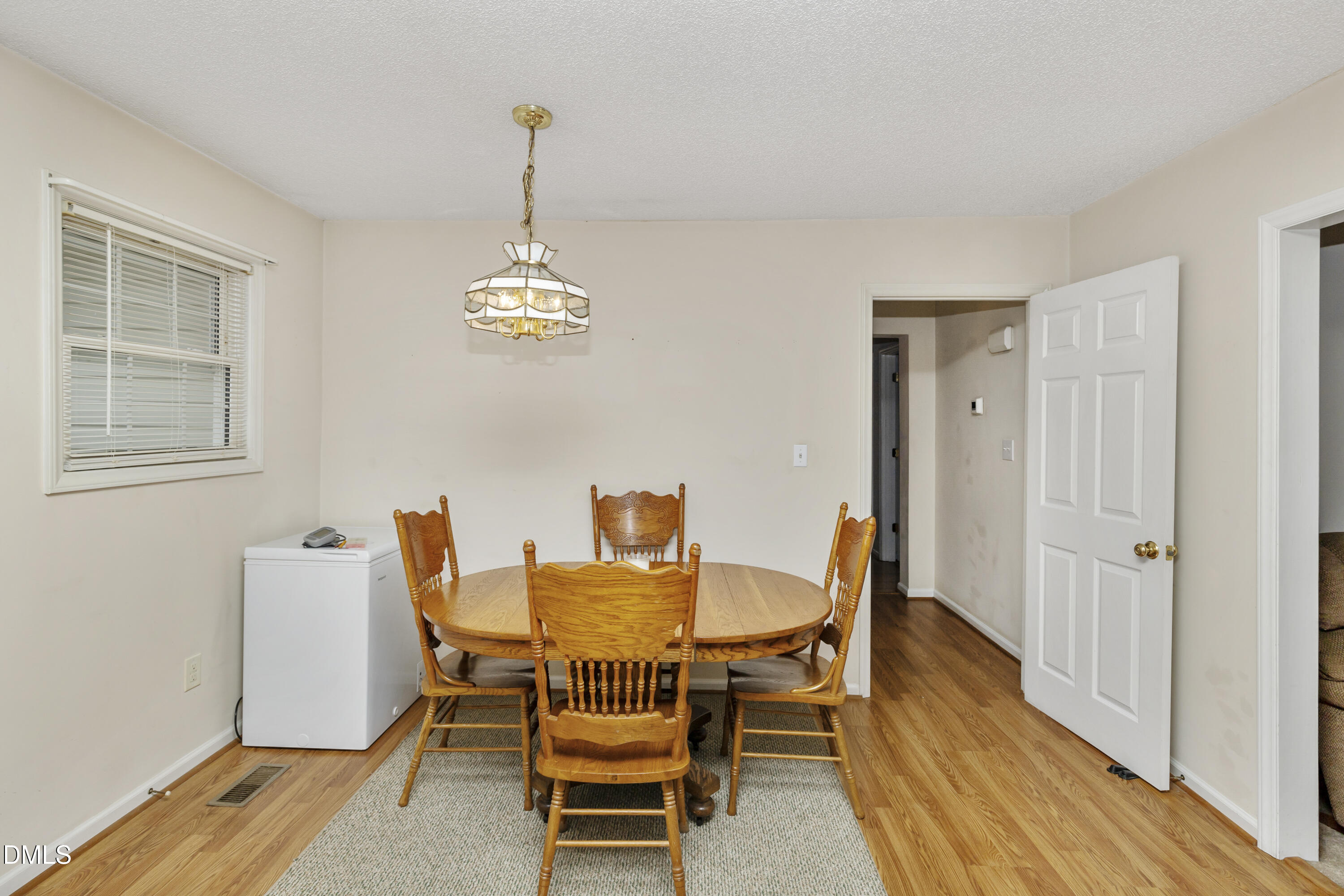 100 East E Street Erwin, NC 28339 - Photo 21 of 27 a dining room with furniture a chandelier and wooden floor