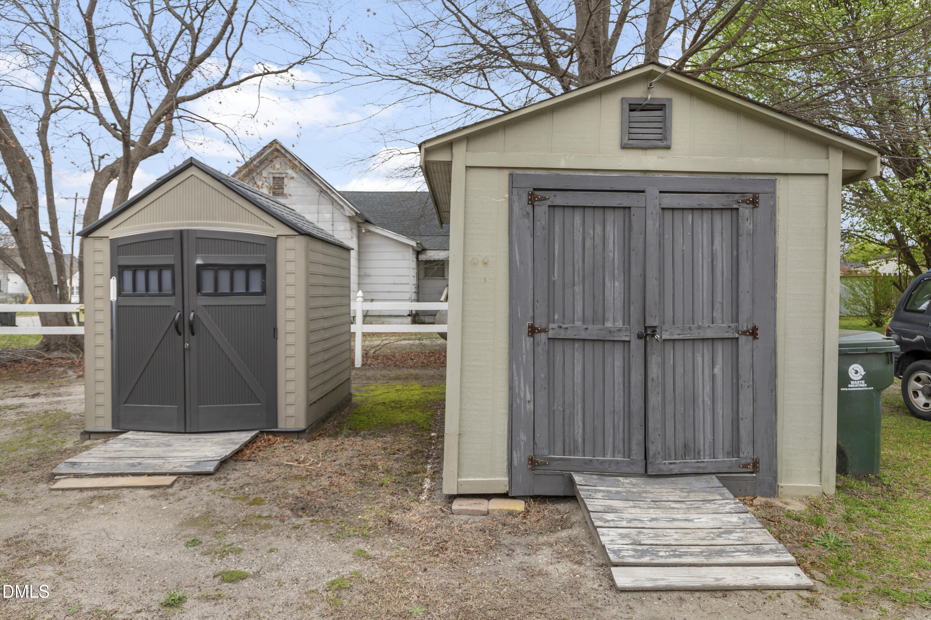 100 East E Street Erwin, NC 28339 - Photo 27 of 27 a view of a wooden house with a small yard and large tree