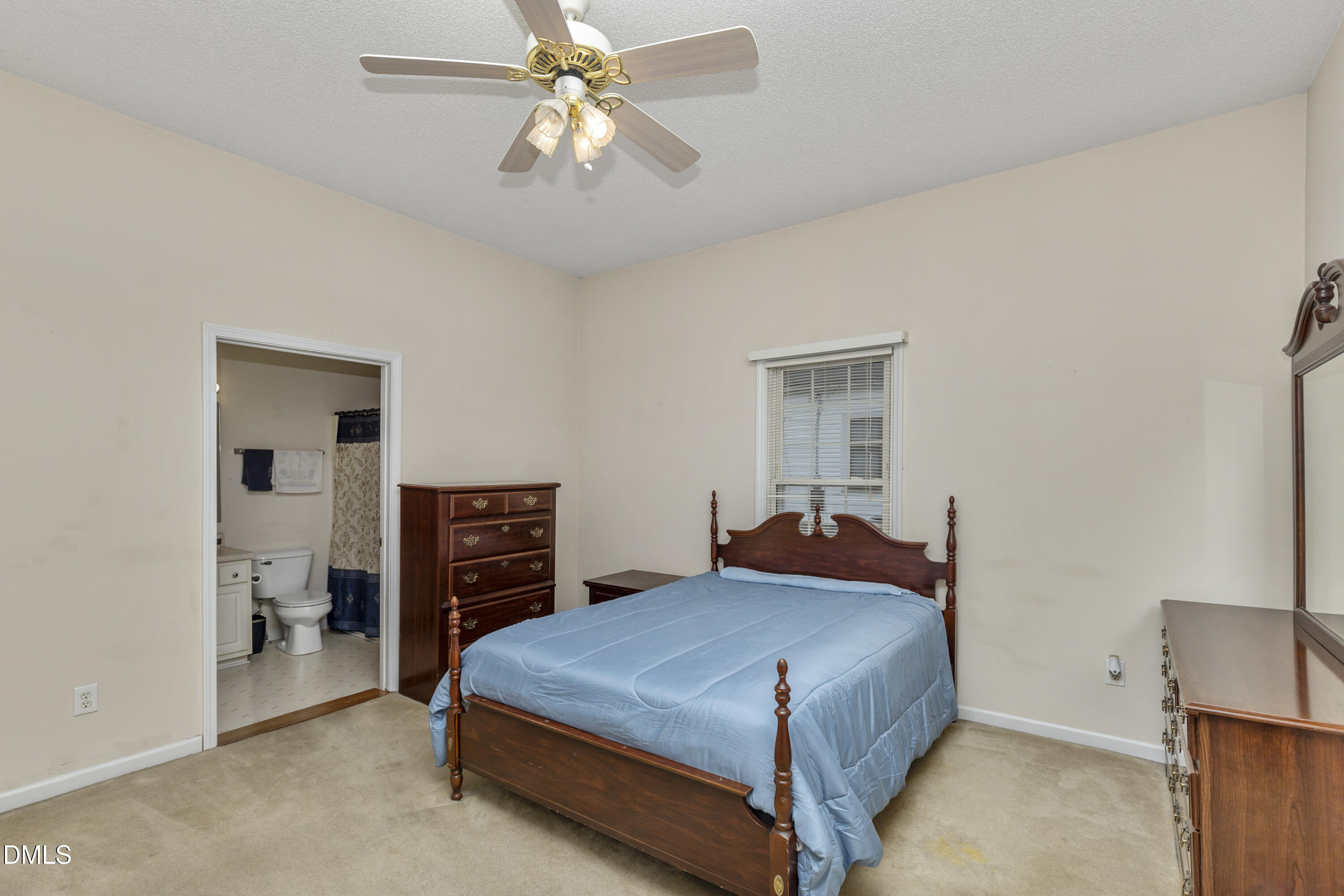 100 East E Street Erwin, NC 28339 - Photo 5 of 27 a bedroom with a bed and a chandelier