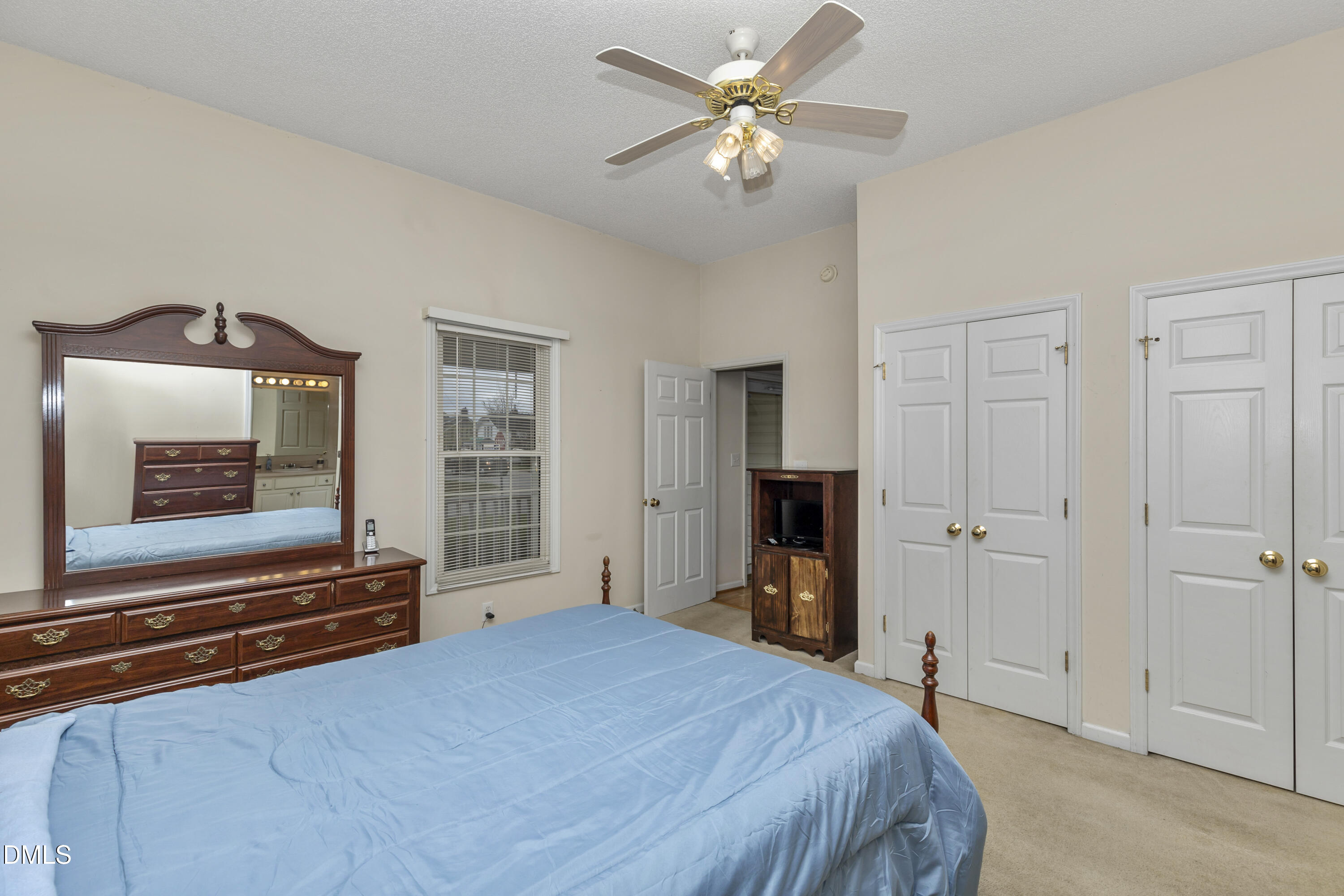 100 East E Street Erwin, NC 28339 - Photo 6 of 27 a bedroom with a bed and a flat tv screen on the dresser