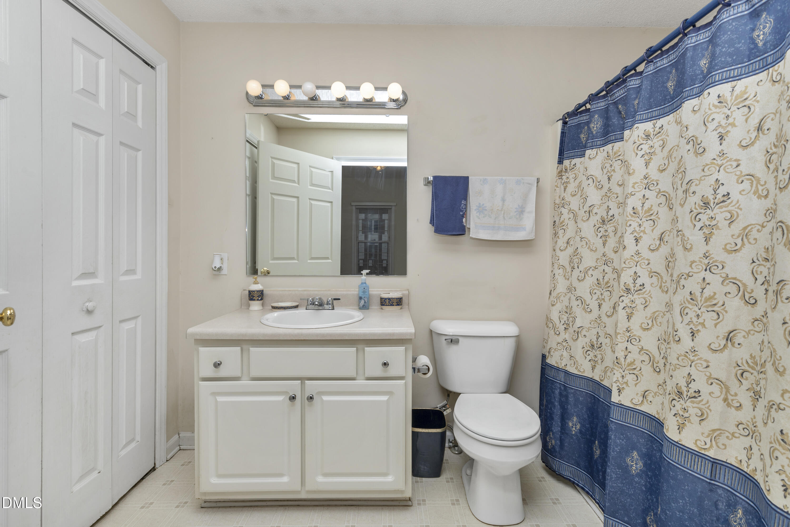 100 East E Street Erwin, NC 28339 - Photo 7 of 27 a bathroom with a toilet sink vanity and mirror