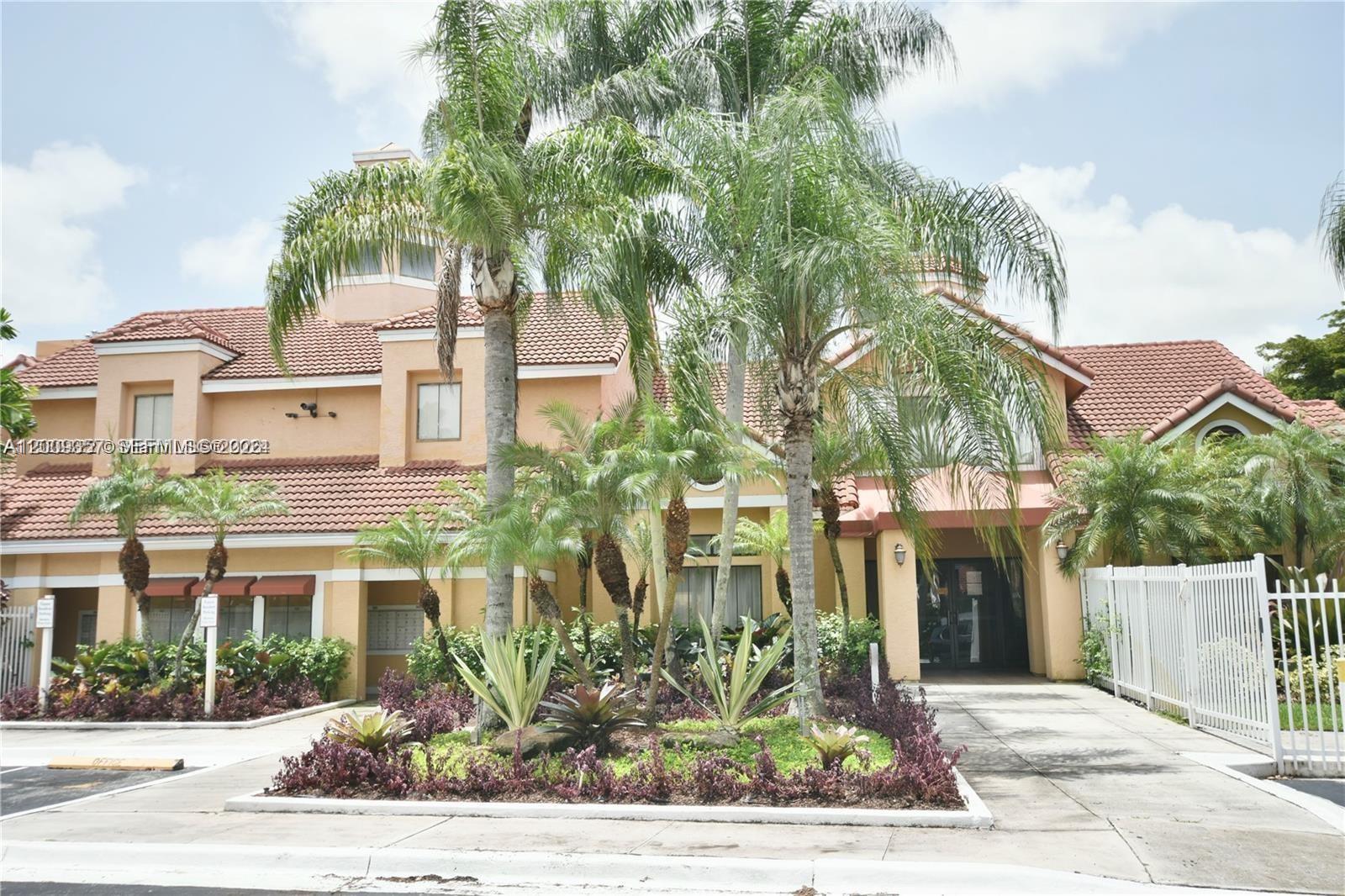 15551 Southwest 104th Terrace, Unit 814 Miami, FL 33196 - Photo 1 of 30 a front view of a building with garden view and trees