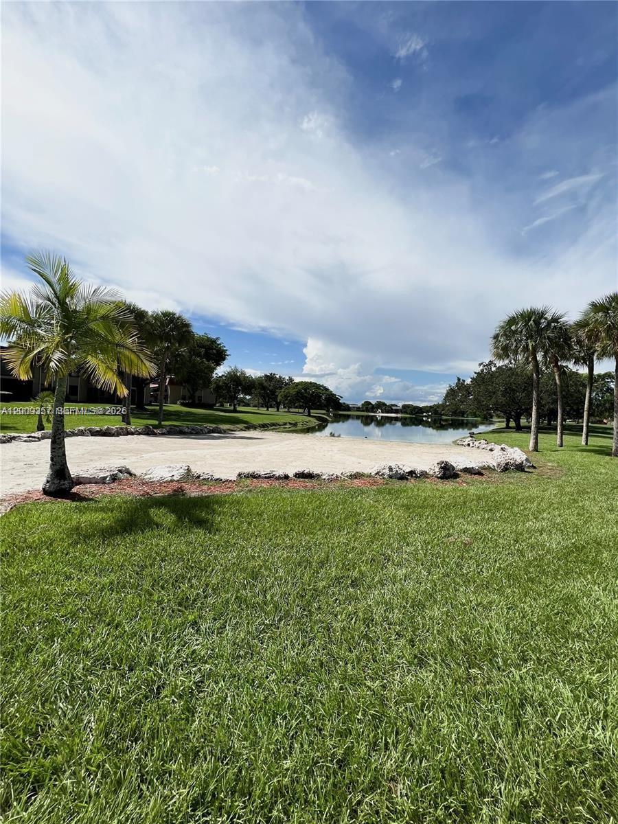 15551 Southwest 104th Terrace, Unit 814 Miami, FL 33196 - Photo 29 of 30 a view of a lake with houses in the background