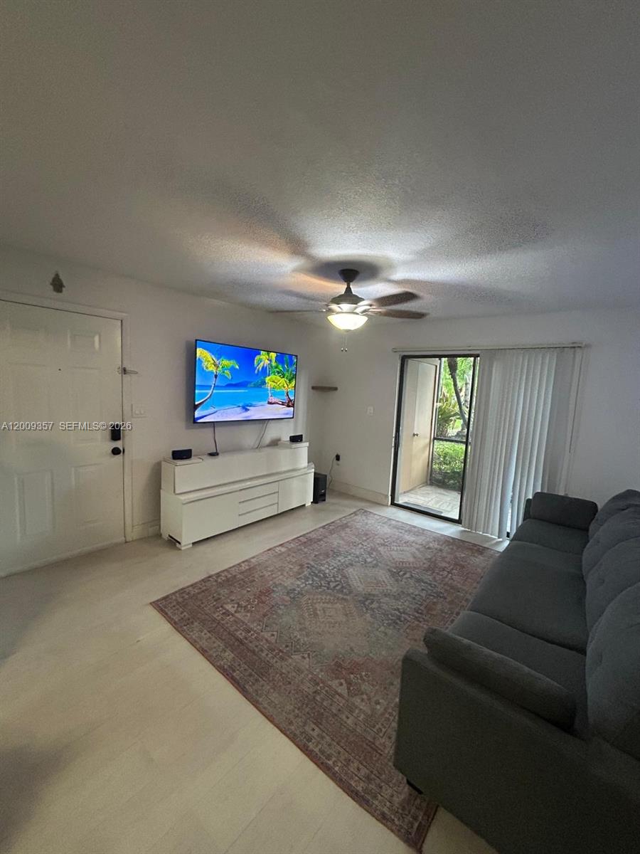 15551 Southwest 104th Terrace, Unit 814 Miami, FL 33196 - Photo 4 of 30 a living room with furniture and a window