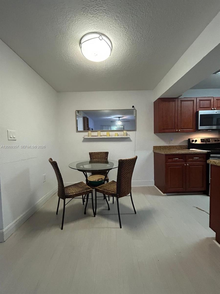15551 Southwest 104th Terrace, Unit 814 Miami, FL 33196 - Photo 7 of 30 a view of a dining room with furniture and a kitchen
