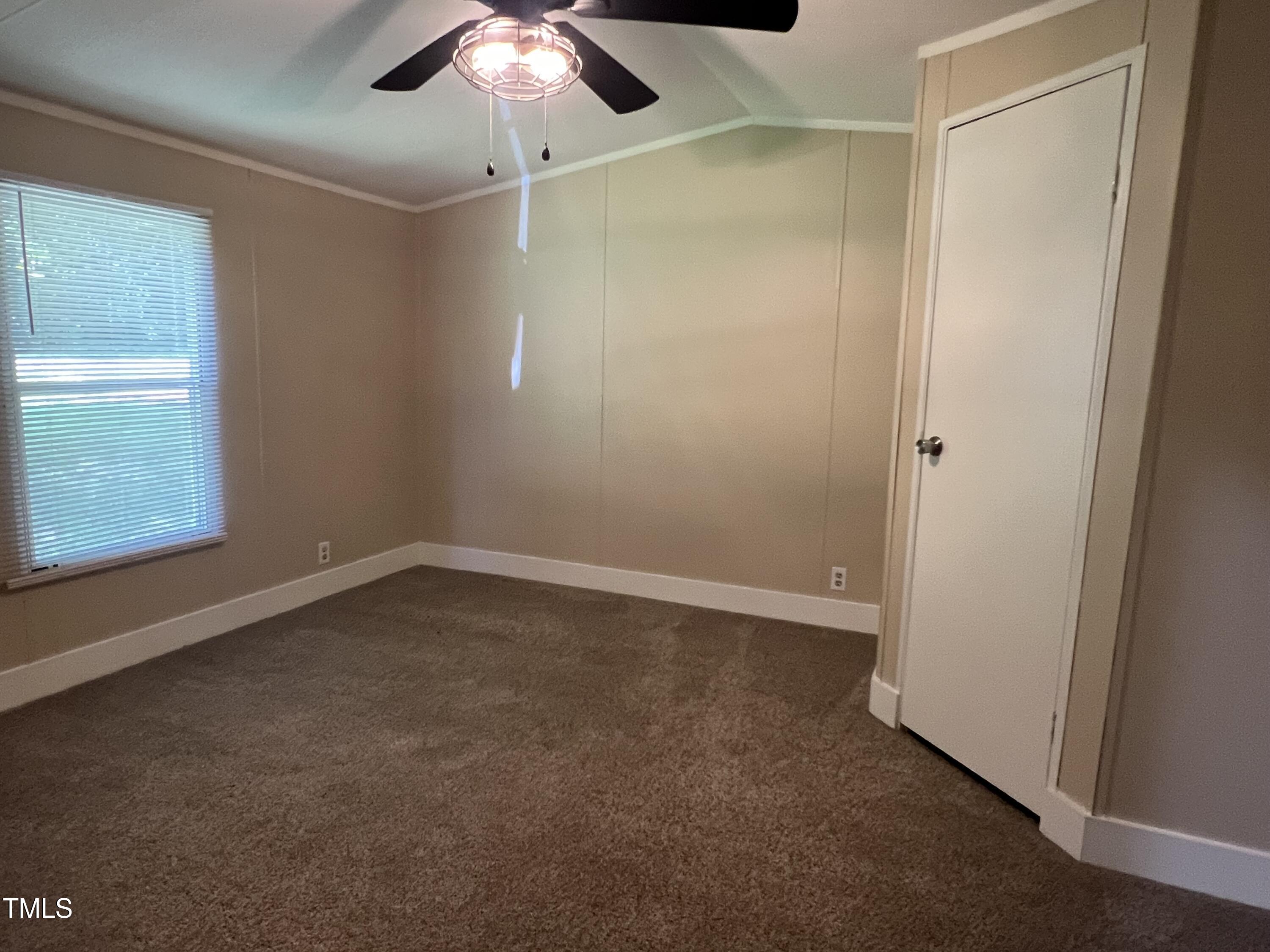 2432 Redwood Road Durham, NC 27704 - Photo 11 of 13 an empty room with a fan & a window
