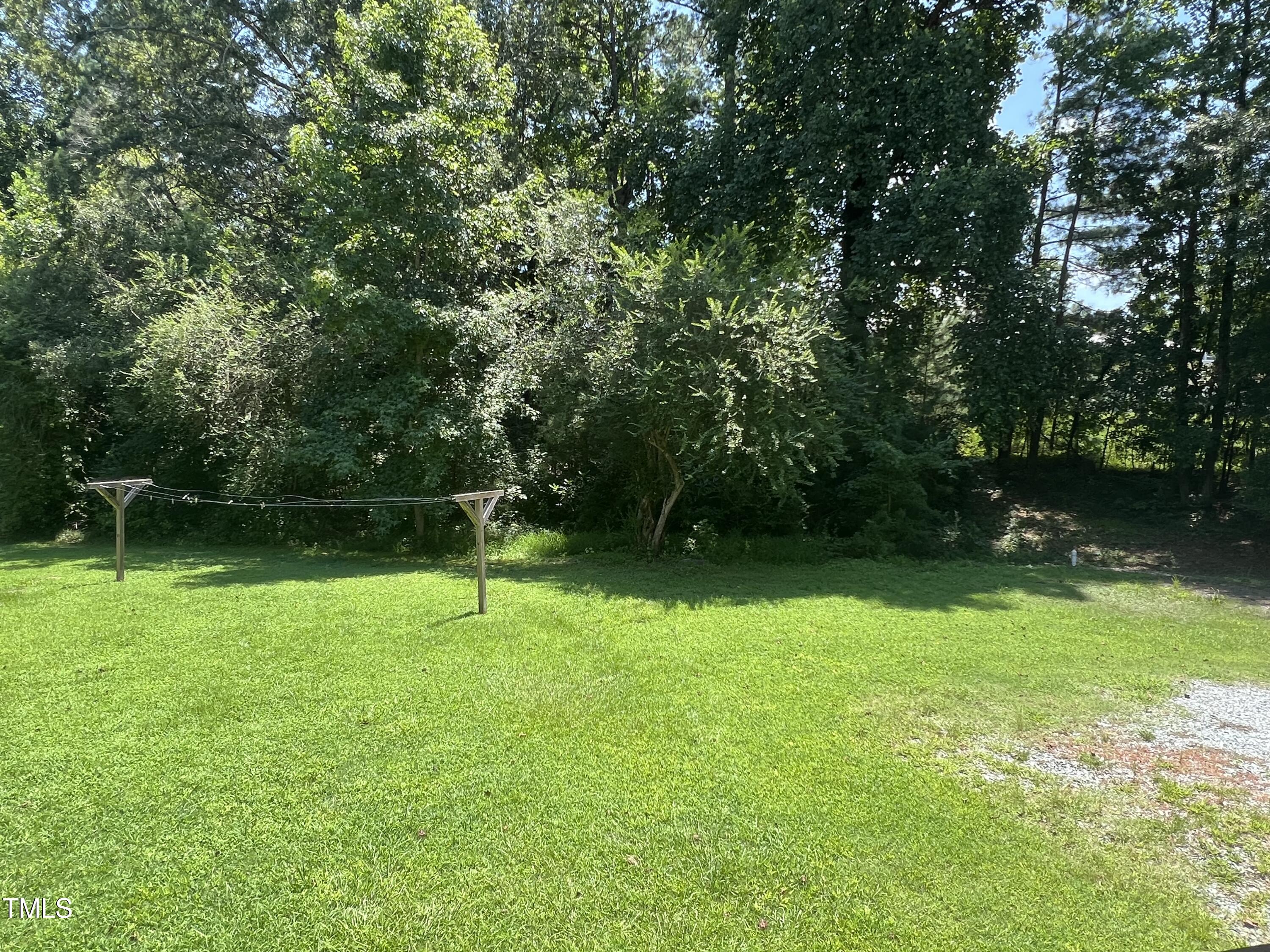 2432 Redwood Road Durham, NC 27704 - Photo 6 of 13 a backyard of a house with lots of green space