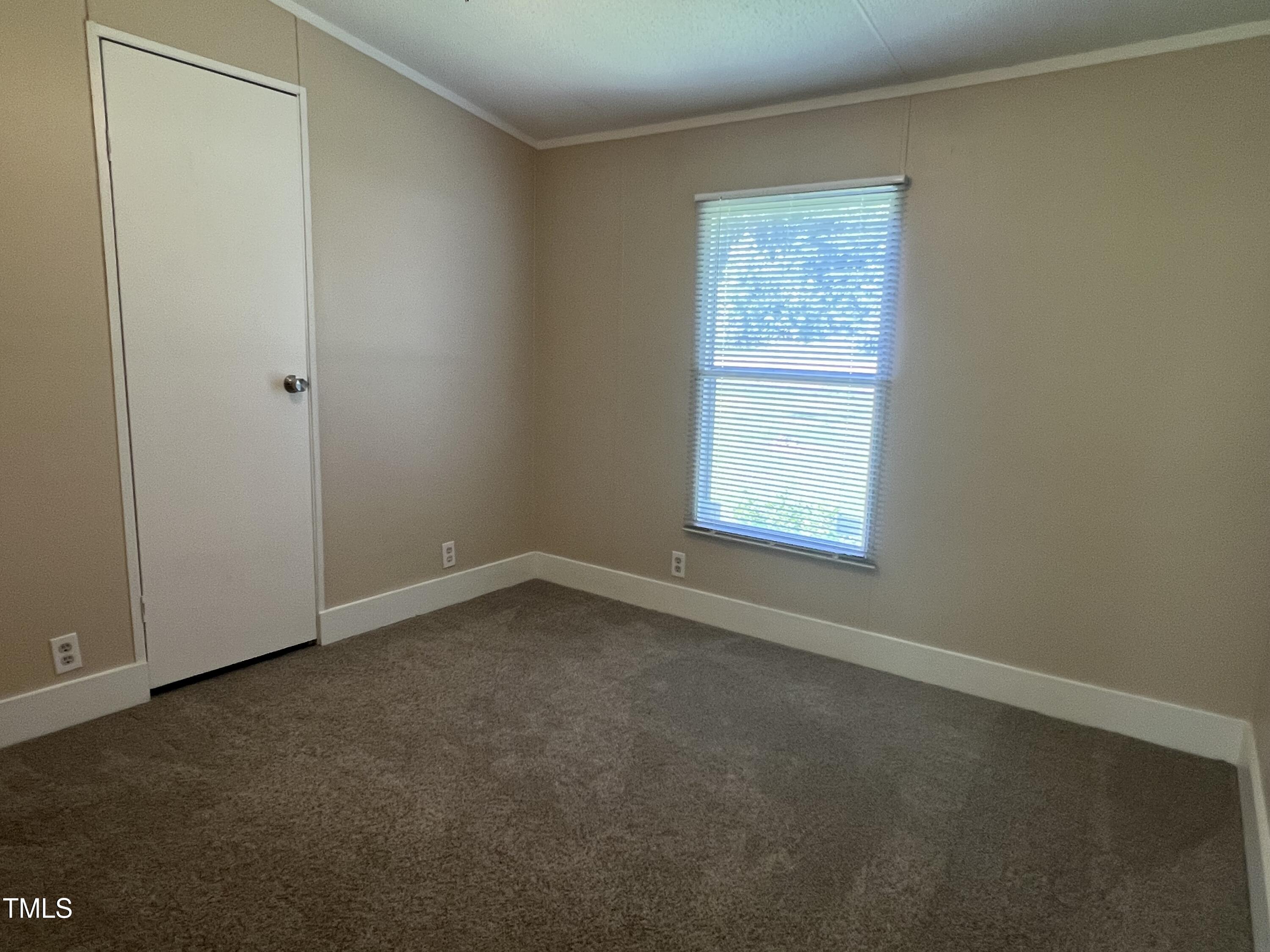 2432 Redwood Road Durham, NC 27704 - Photo 10 of 13 an empty room with a window