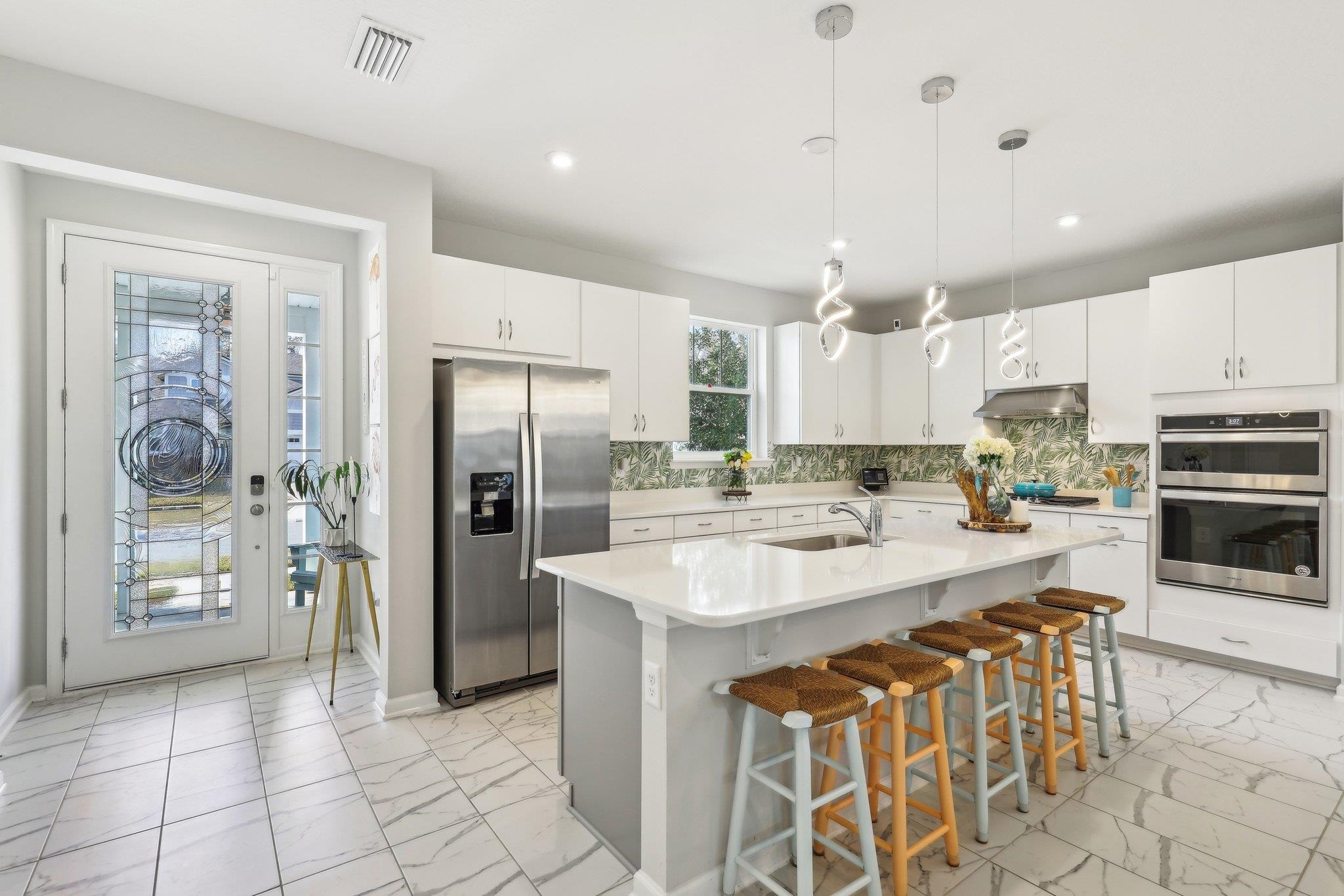 352 Footbridge Road St. Johns, FL 32259 - Photo 17 of 66 a kitchen with stainless steel appliances granite countertop a refrigerator a sink a stove and white cabinets