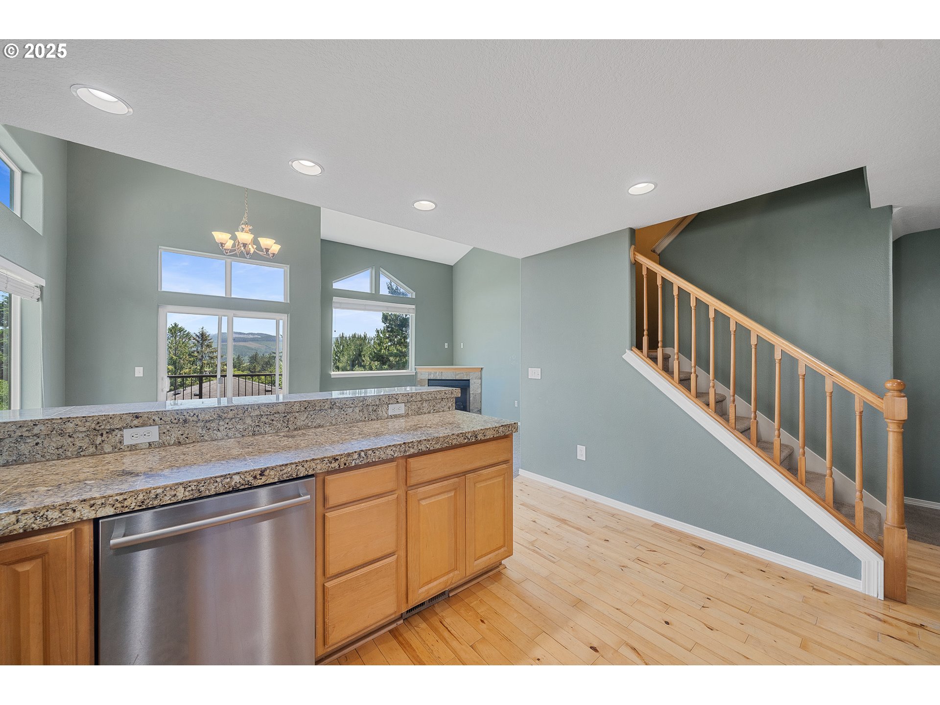 13150 D Street Nehalem, OR 97131 - Photo 18 of 42 a open kitchen with kitchen island a sink dishwasher a stove and a large island with wooden floor