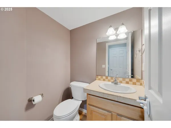 a bathroom with a sink toilet and mirror