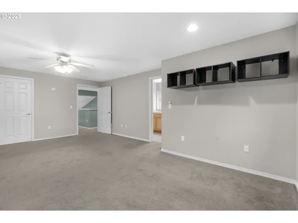 a view of an empty room with a ceiling fan