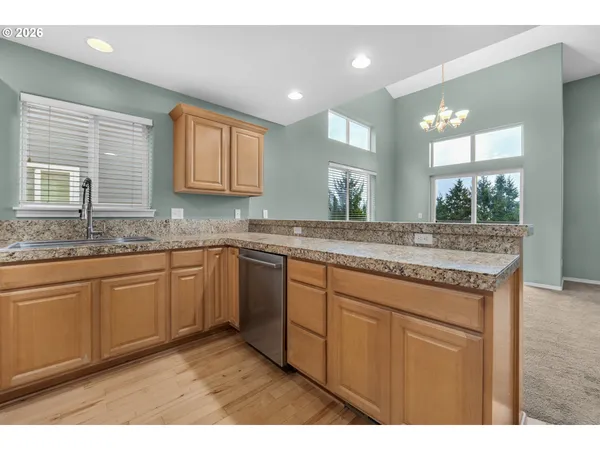 a kitchen with stainless steel appliances granite countertop a stove microwave and cabinets