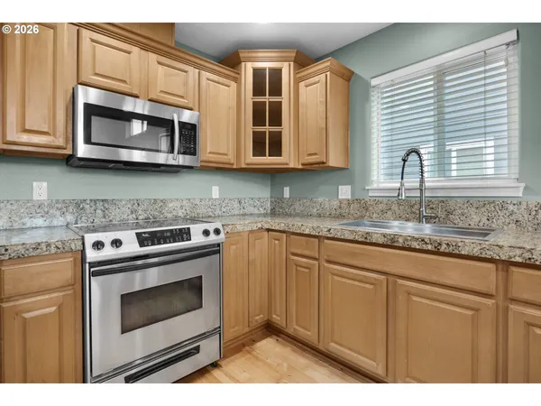 a kitchen with a sink cabinets and wooden floor