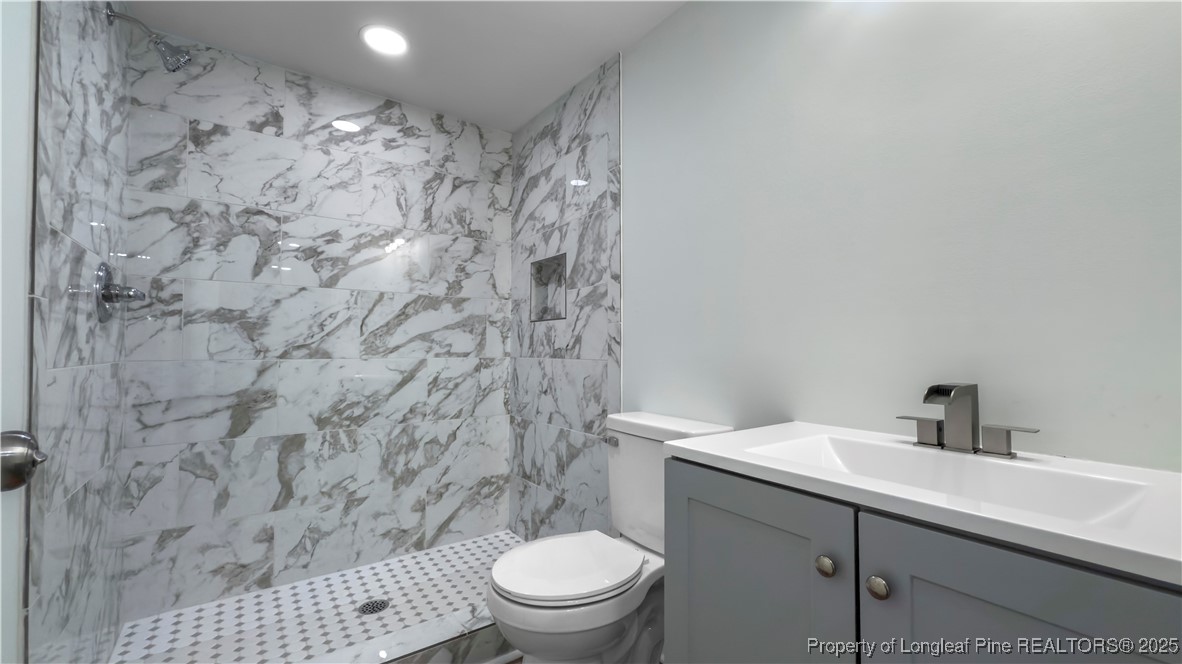 1340 George Perry Lee Road Dunn, NC 28334 - Photo 31 of 31 a bathroom with a toilet and a sink