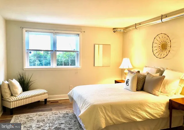 a bedroom with a bed and couch