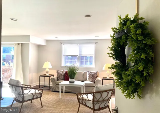 a living room with furniture and a potted plant