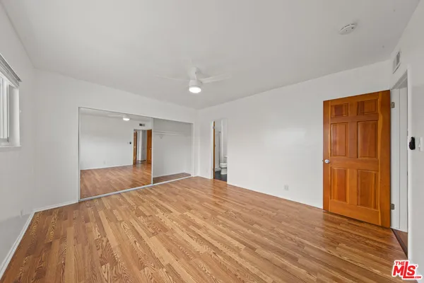 a view of an empty room and wooden floor