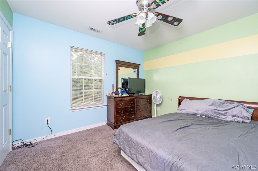 264 Scotch Pine Drive Sandston, VA 23150 - Photo 22 of 26 a bedroom with a bed and a dresser